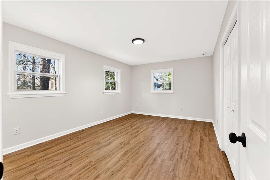 2497 Glenrock Drive Decatur, GA 30032 - Photo 17 of 42 a view of an empty room with wooden floor and a window