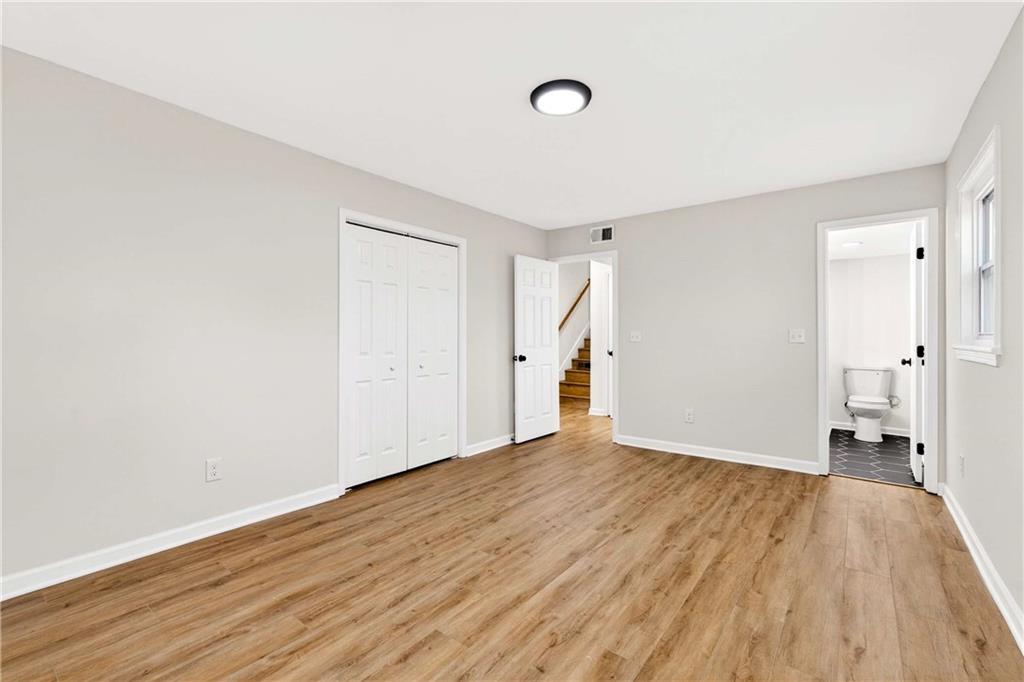 2497 Glenrock Drive Decatur, GA 30032 - Photo 18 of 42 a view of empty room with wooden floor