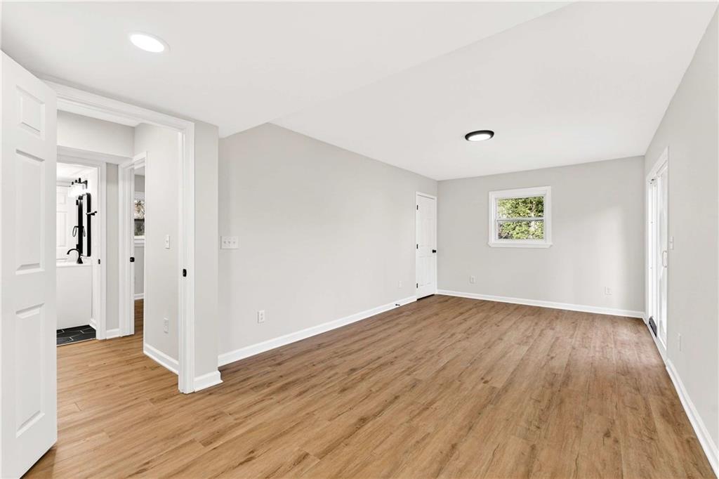 2497 Glenrock Drive Decatur, GA 30032 - Photo 20 of 42 an empty room with wooden floor and windows