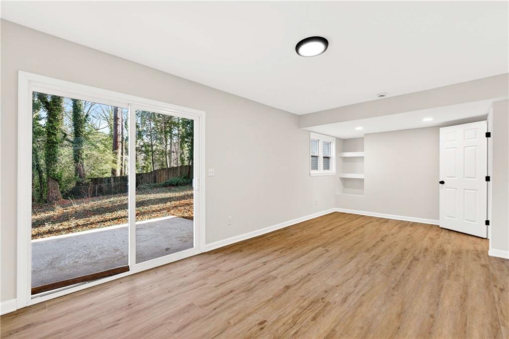 2497 Glenrock Drive Decatur, GA 30032 - Photo 21 of 42 a view of empty room with wooden floor and fan