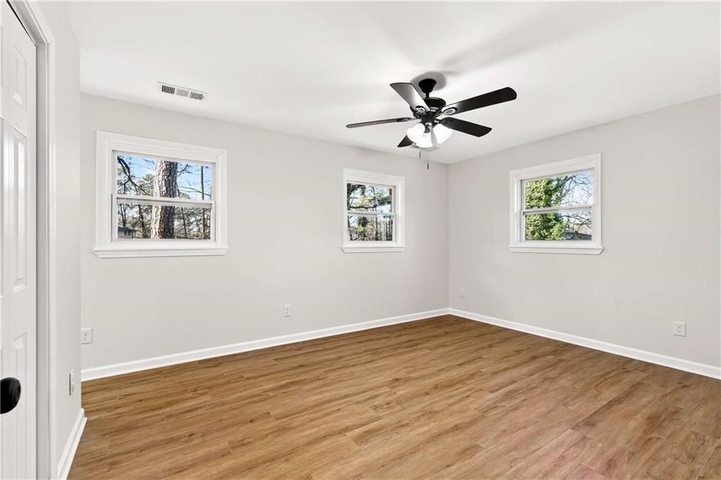 2497 Glenrock Drive Decatur, GA 30032 - Photo 24 of 42 a view of a big room with wooden floor and windows