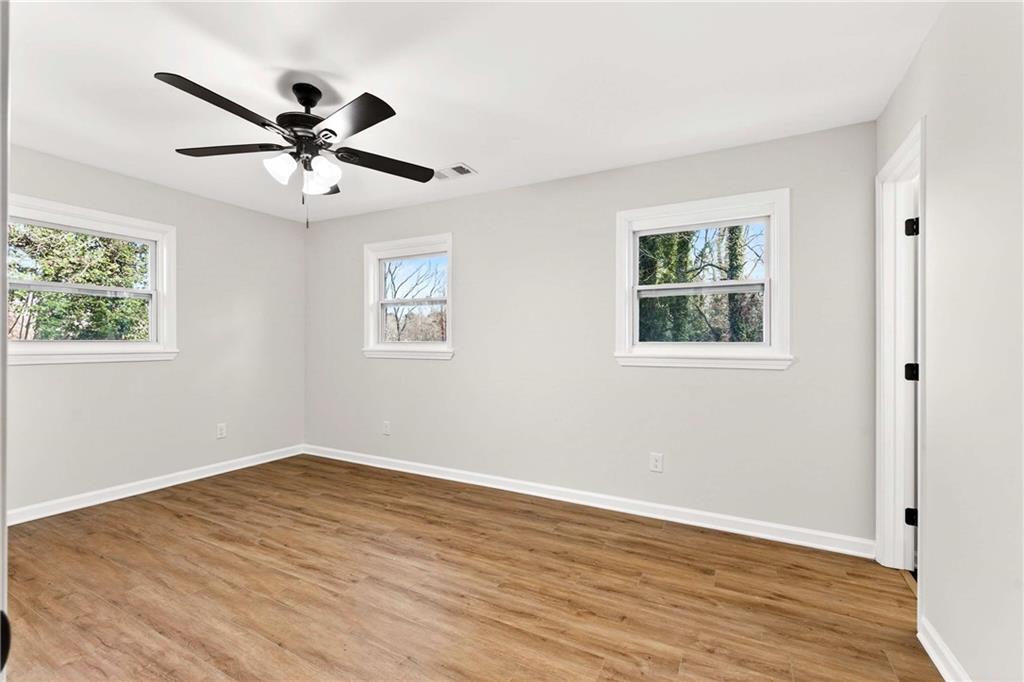 2497 Glenrock Drive Decatur, GA 30032 - Photo 25 of 42 a view of a big room with wooden floor closet and windows