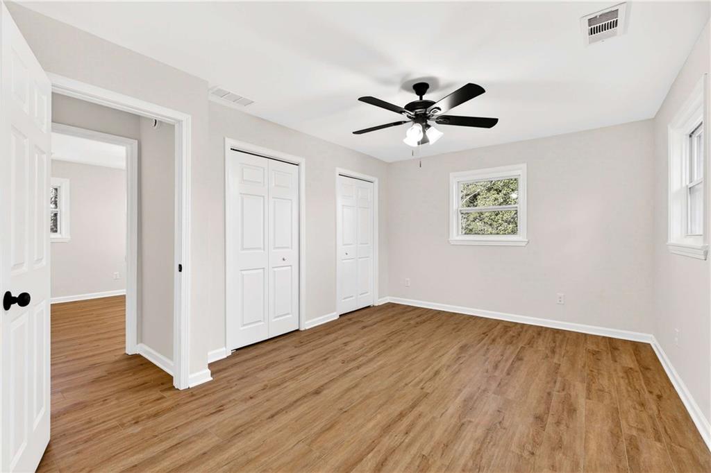 2497 Glenrock Drive Decatur, GA 30032 - Photo 26 of 42 a view of a room with wooden floor and a ceiling fan