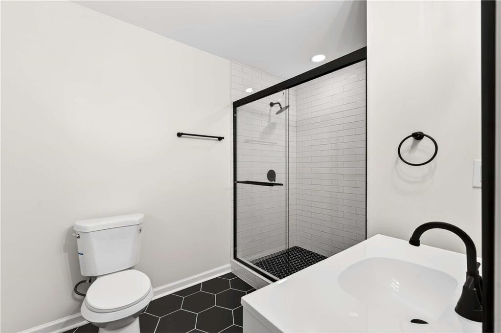 2497 Glenrock Drive Decatur, GA 30032 - Photo 29 of 42 a bathroom with a sink a toilet and shower