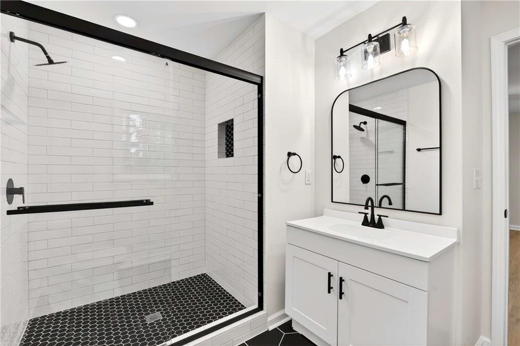 2497 Glenrock Drive Decatur, GA 30032 - Photo 30 of 42 a bathroom with a sink a mirror and shower