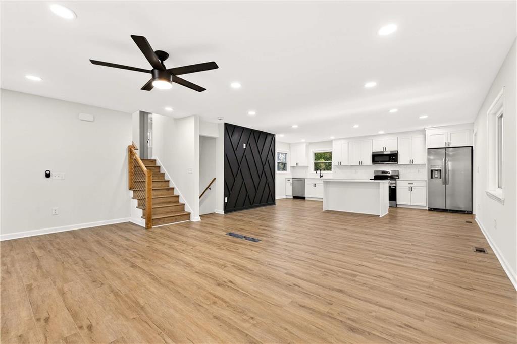 2497 Glenrock Drive Decatur, GA 30032 - Photo 6 of 42 a view of a livingroom with a ceiling fan wooden floor and staircase