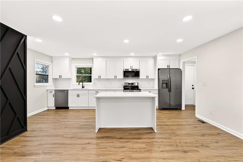 2497 Glenrock Drive Decatur, GA 30032 - Photo 7 of 42 a kitchen with stainless steel appliances a refrigerator sink and cabinets