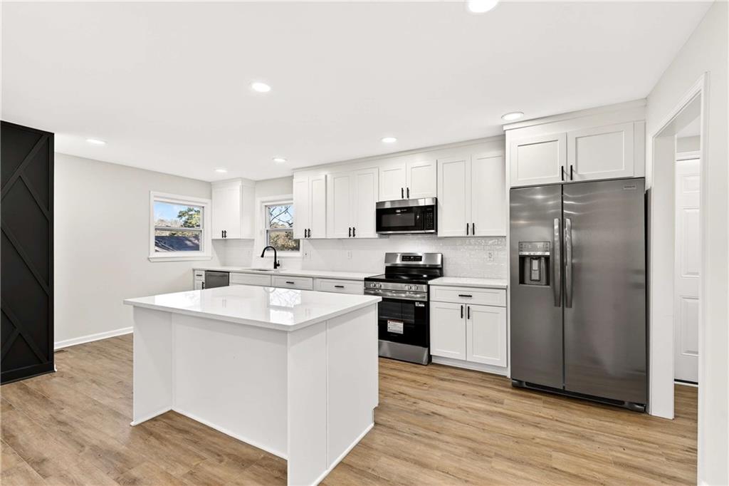 2497 Glenrock Drive Decatur, GA 30032 - Photo 9 of 42 a kitchen with a sink a refrigerator a stove and cabinets