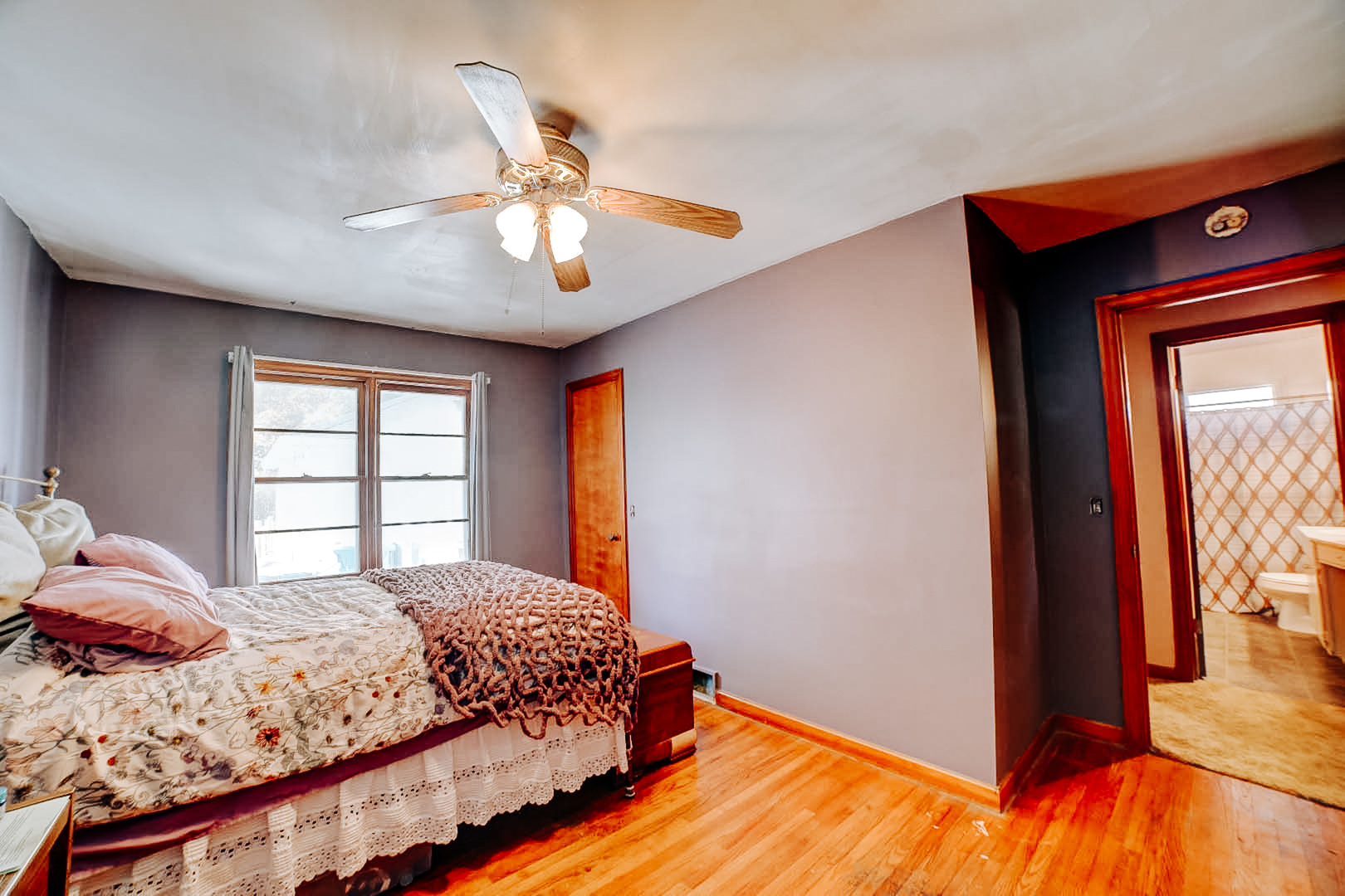 615 South 5th Street Watseka, IL 60970 - Photo 18 of 26 a bedroom with a bed and a chandelier