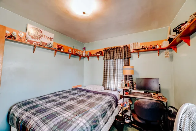 a bedroom with a bed and a couch