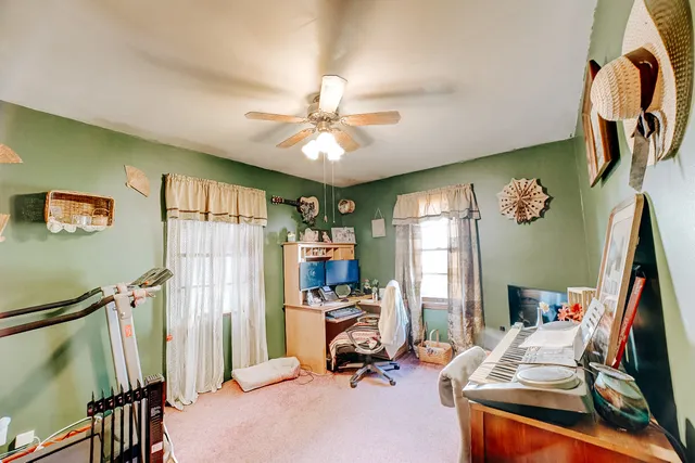 a view of a workspace with furniture and a window