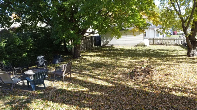 a view of a house with backyard and sitting area