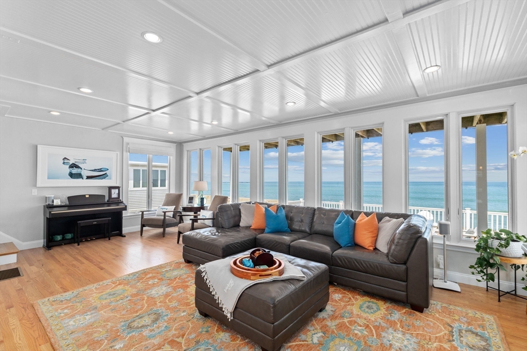 79 Surfside Road Scituate, MA 02066 - Photo 11 of 42 a living room with furniture and large windows