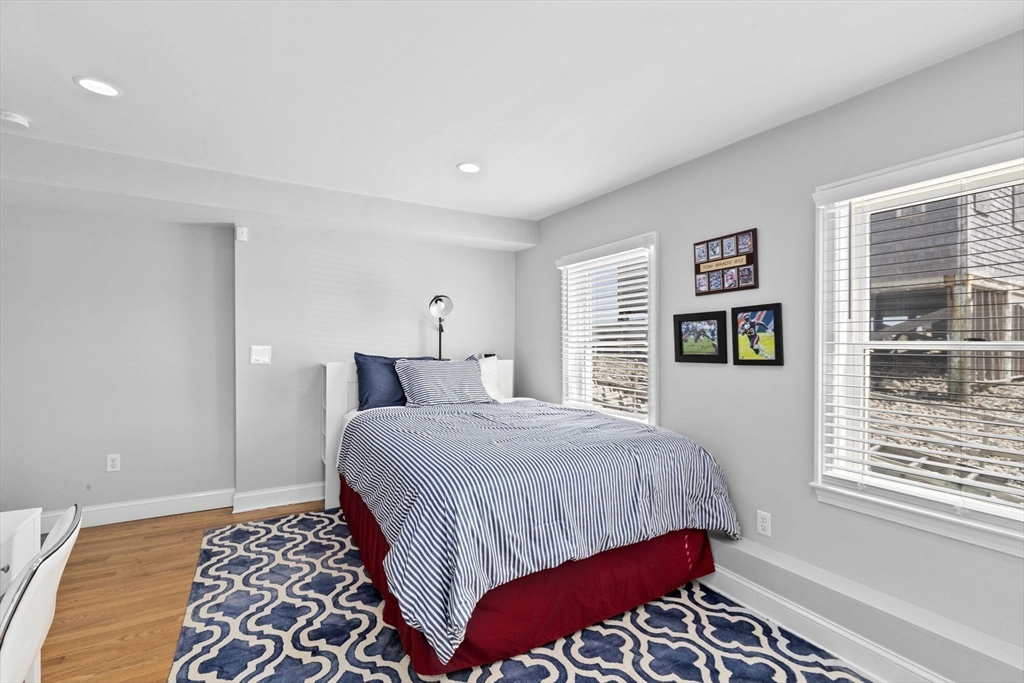 79 Surfside Road Scituate, MA 02066 - Photo 29 of 42 a bedroom with a bed and wooden floor
