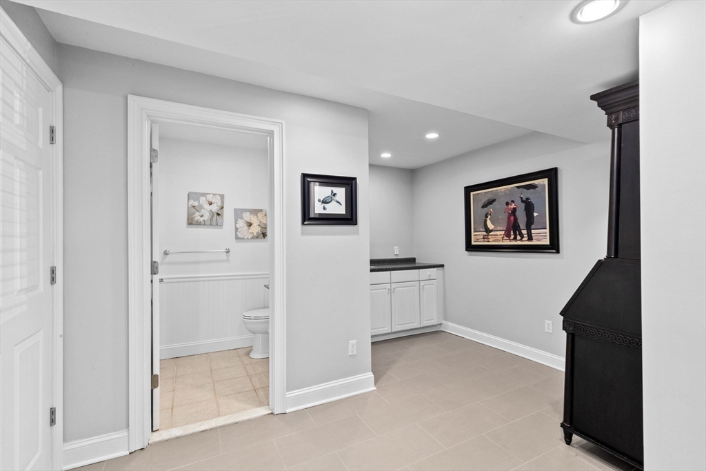 79 Surfside Road Scituate, MA 02066 - Photo 33 of 42 a view of a hallway with paintings on the wall