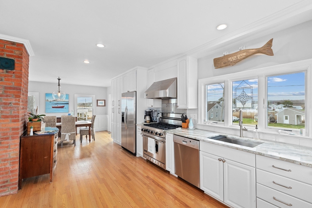 79 Surfside Road Scituate, MA 02066 - Photo 8 of 42 a large kitchen with a table and chairs