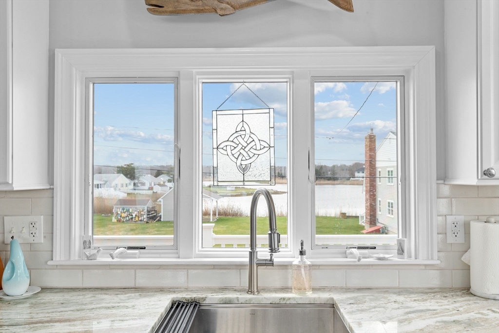 79 Surfside Road Scituate, MA 02066 - Photo 10 of 42 a view of front door with a bench and floor to ceiling window