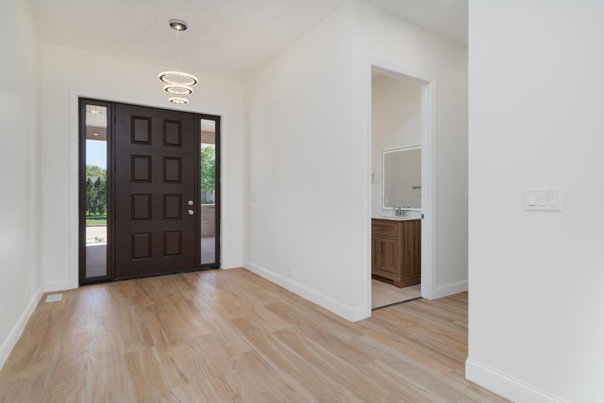 5145 Sycamore Ridge Road Belvidere, IL 61008 - Photo 7 of 57 a view of an empty room with wooden floor & windows
