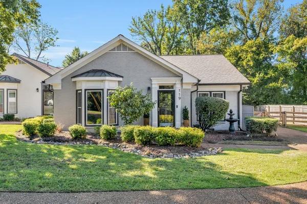 a front view of a house with garden