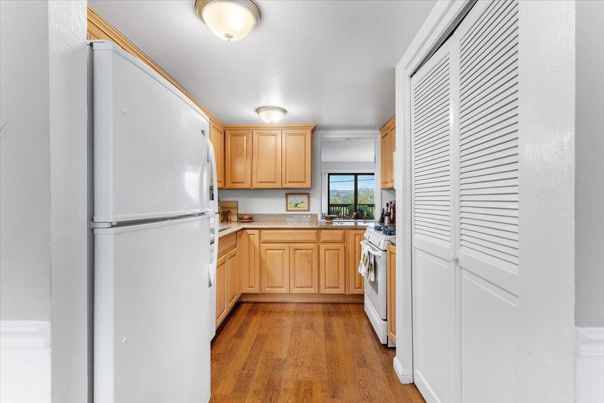 19100 Crest Avenue, Unit 15 Castro Valley, CA 94546 - Photo 12 of 33 a kitchen with a refrigerator a sink and dishwasher a oven with wooden floor