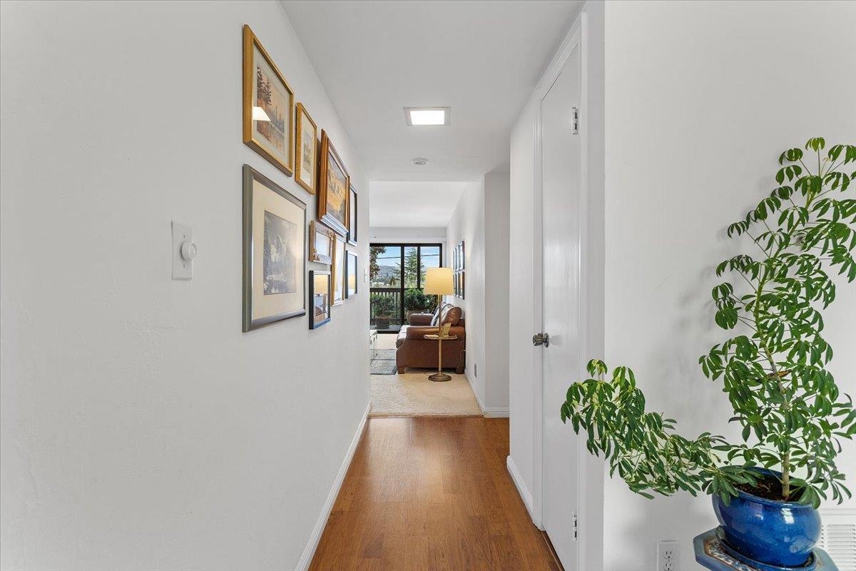 19100 Crest Avenue, Unit 15 Castro Valley, CA 94546 - Photo 4 of 33 a view of a hallway with wooden floor and a potted plant