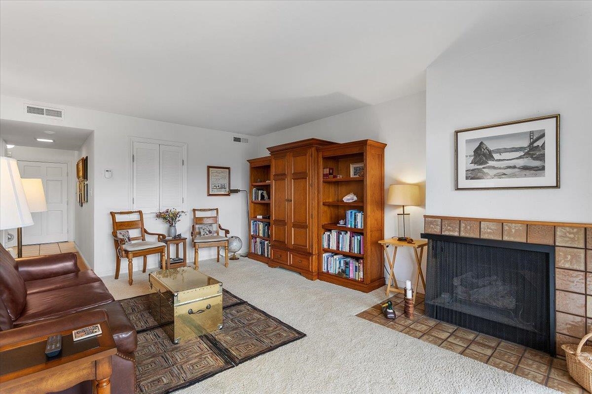 19100 Crest Avenue, Unit 15 Castro Valley, CA 94546 - Photo 7 of 33 a living room with furniture a dining table and a fireplace