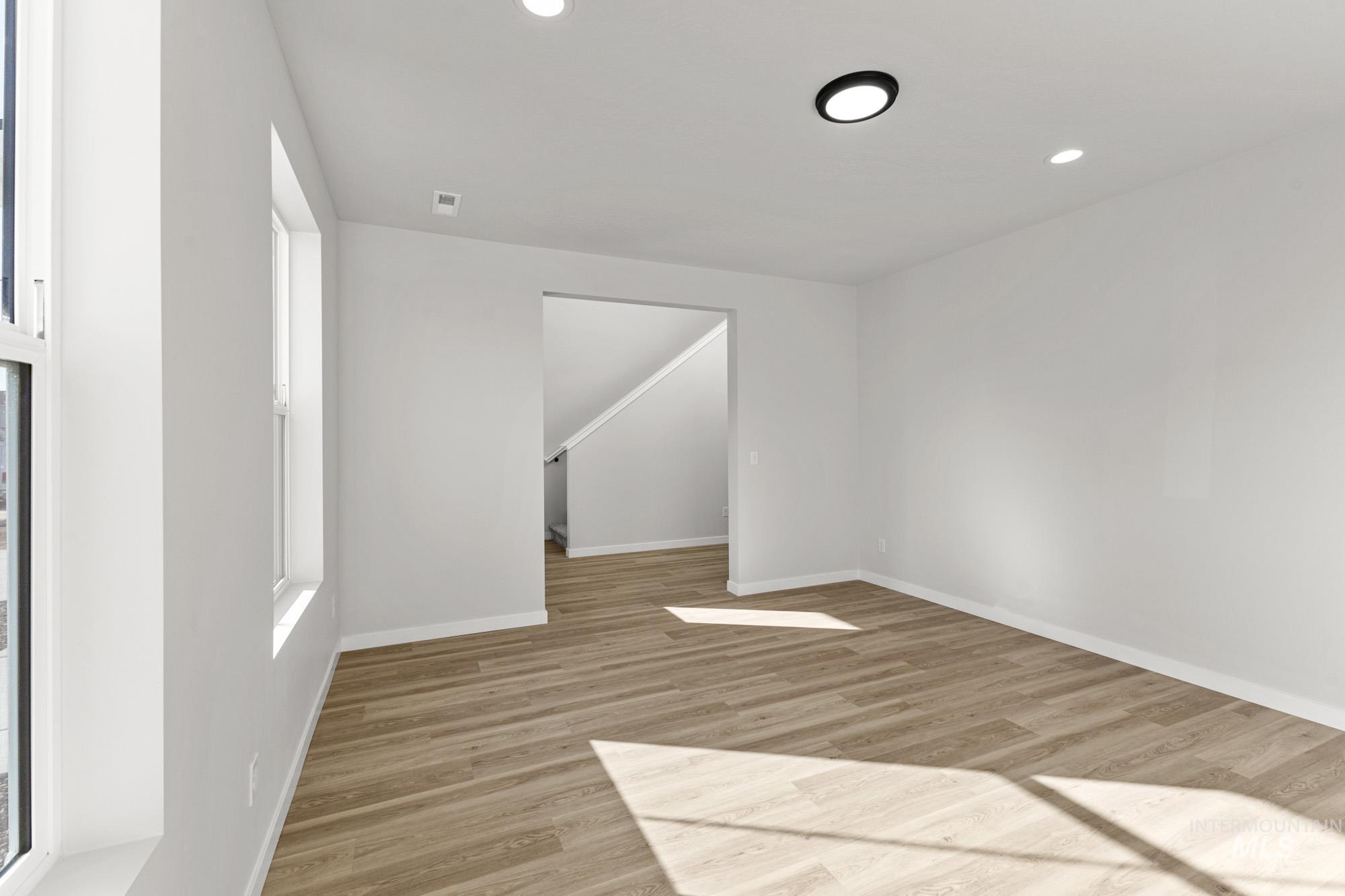 13708 Judson Street Caldwell, ID 83607 - Photo 13 of 29 Empty room featuring light wood finished floors and recessed lighting