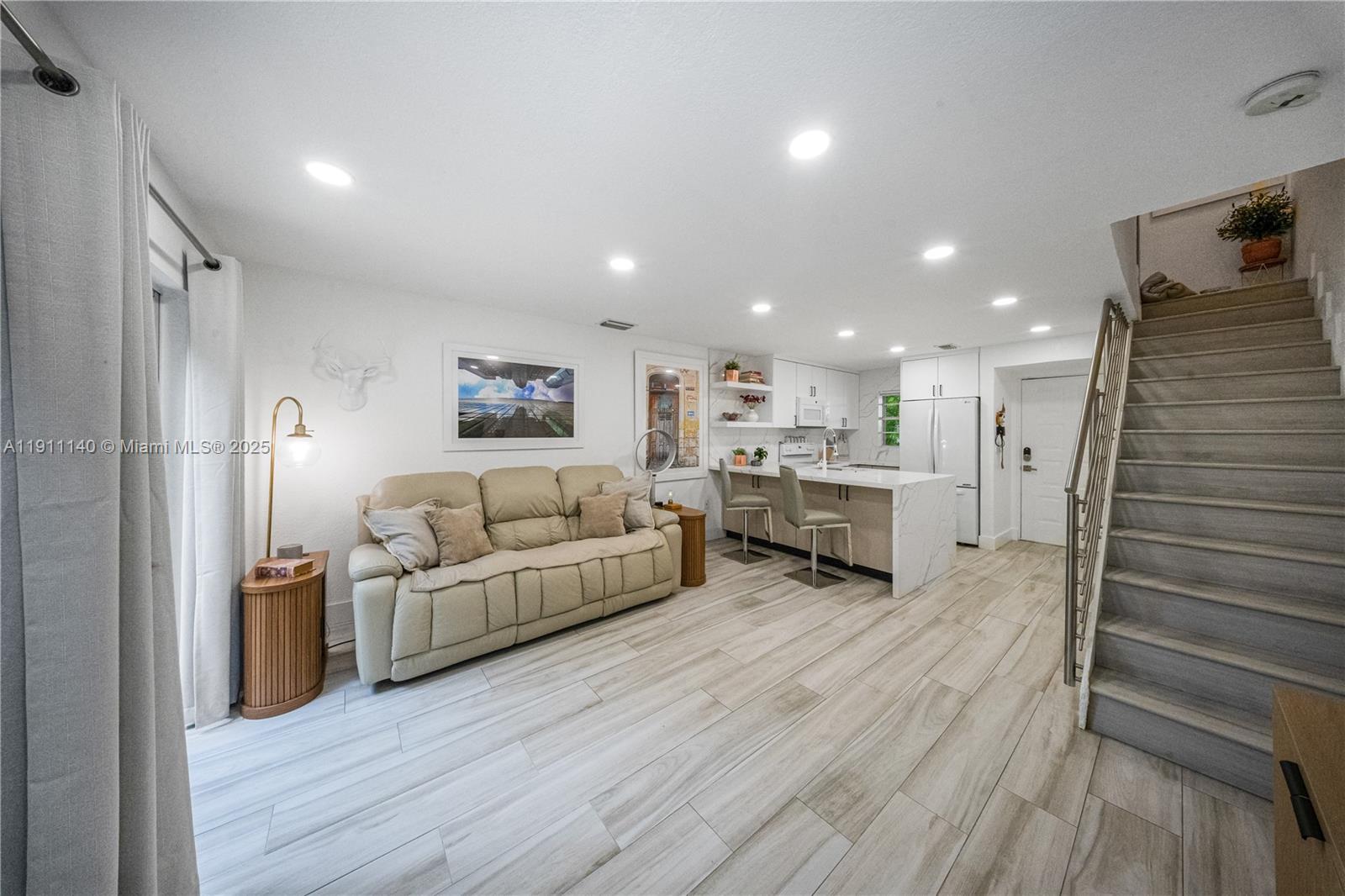 3130 Bird Avenue, Unit 12 Miami, FL 33133 - Photo 12 of 23 a living room with furniture and a wooden floor