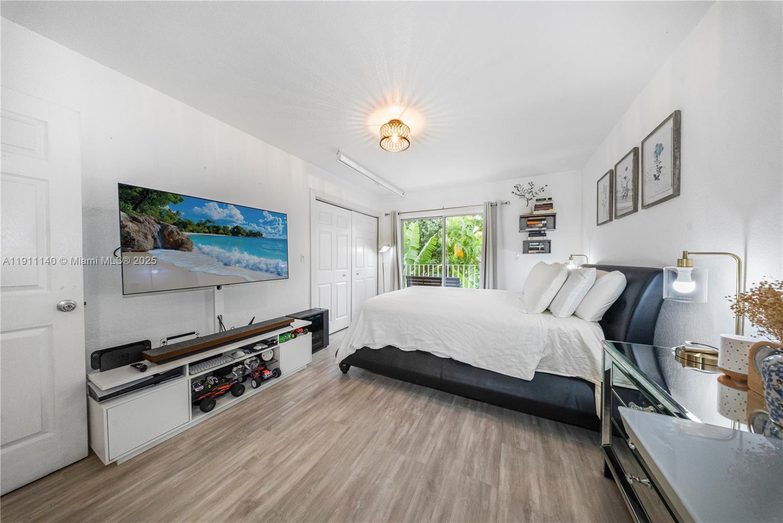 3130 Bird Avenue, Unit 12 Miami, FL 33133 - Photo 15 of 23 a spacious bedroom with a bed and a flat screen tv