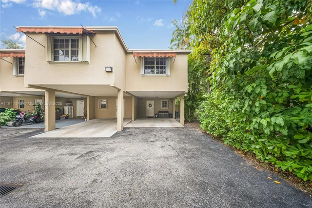 a view of a house with a yard and a garage