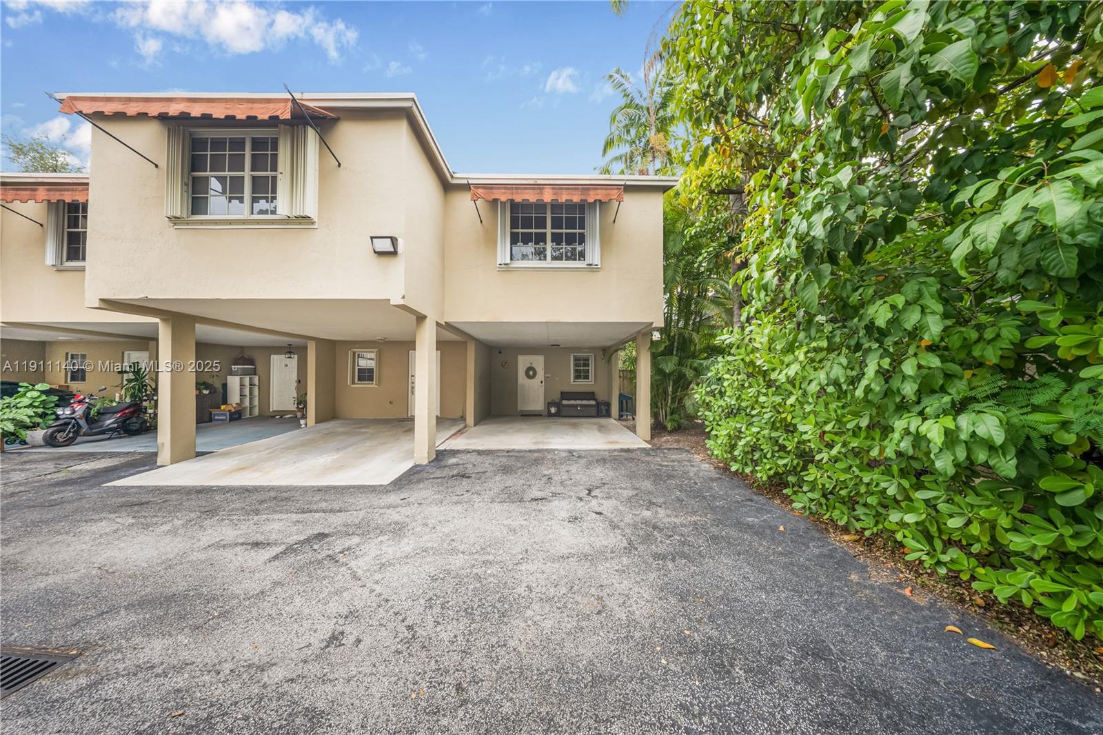 3130 Bird Avenue, Unit 12 Miami, FL 33133 - Photo 2 of 23 a view of a house with a yard and a garage