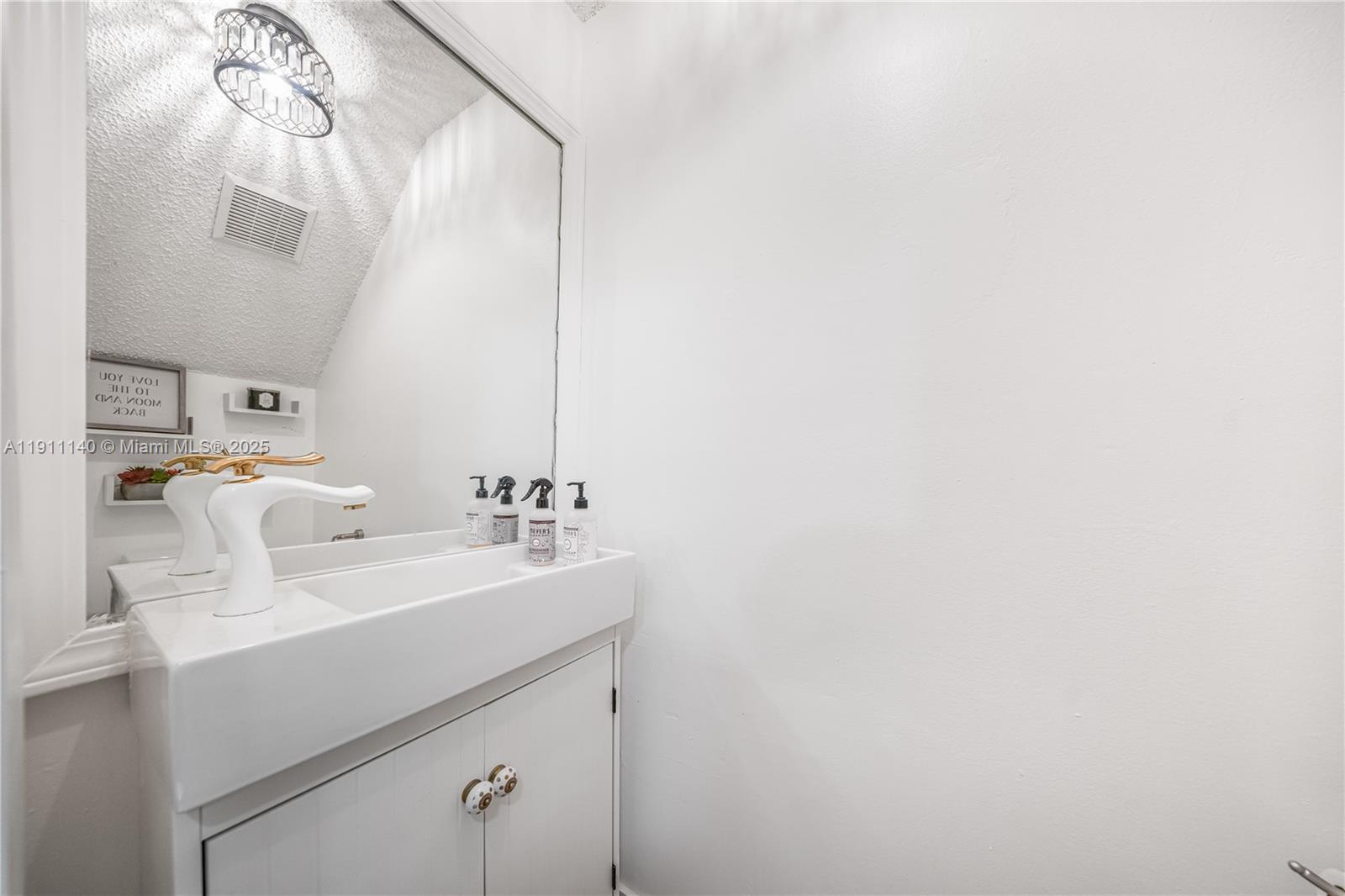 3130 Bird Avenue, Unit 12 Miami, FL 33133 - Photo 5 of 23 a bathroom with a sink and a mirror
