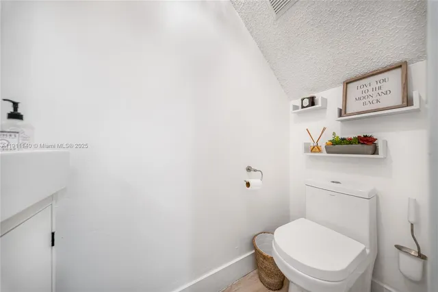 a white toilet sitting next to a bathroom sink