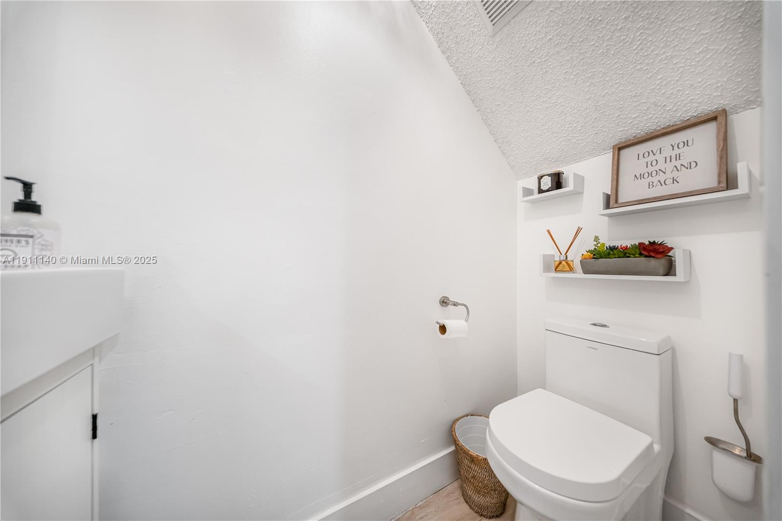 3130 Bird Avenue, Unit 12 Miami, FL 33133 - Photo 6 of 23 a white toilet sitting next to a bathroom sink