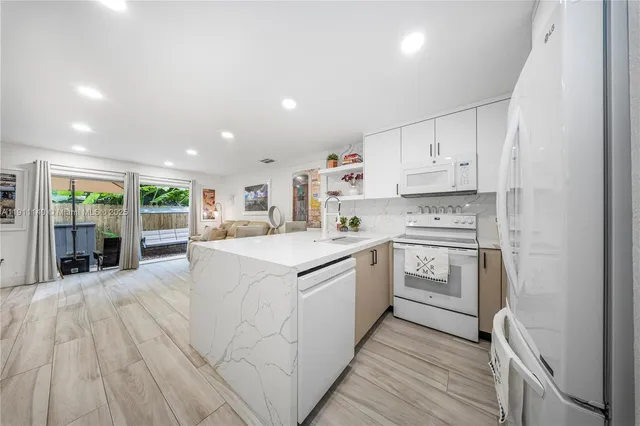 a kitchen with stainless steel appliances sink refrigerator and microwave