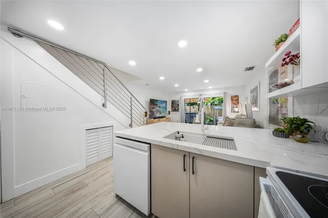 a kitchen with a sink and a refrigerator