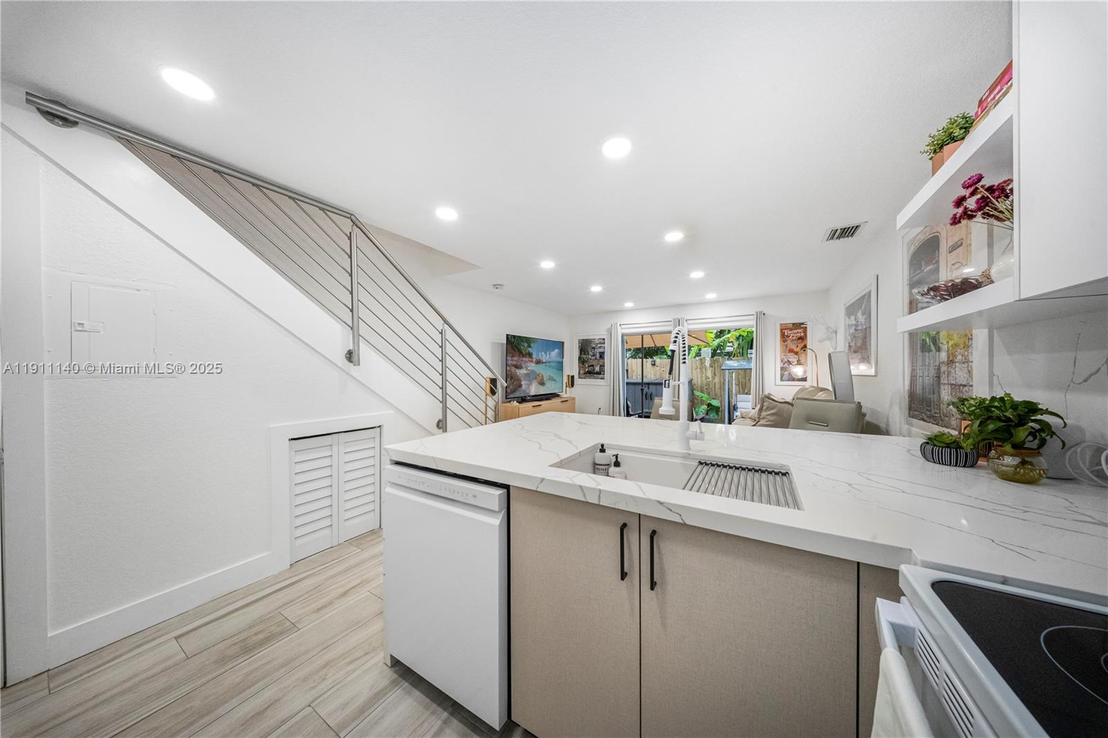 3130 Bird Avenue, Unit 12 Miami, FL 33133 - Photo 8 of 23 a kitchen with a sink and a refrigerator