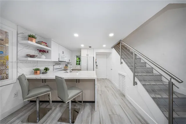 a view of kitchen with sink and wooden floor