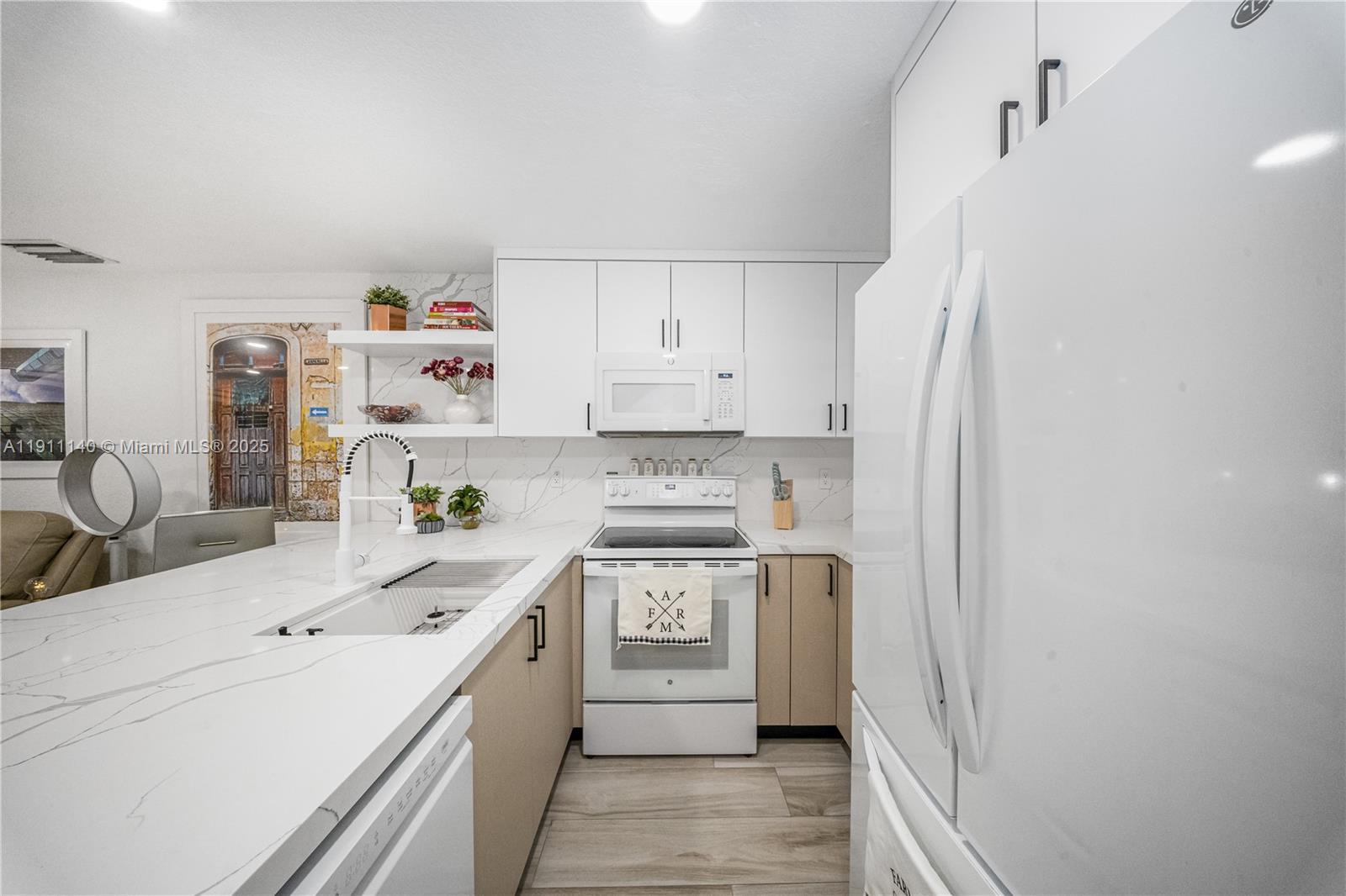3130 Bird Avenue, Unit 12 Miami, FL 33133 - Photo 10 of 23 a kitchen with a sink a stove and refrigerator