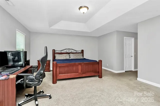 a living room with furniture a flat screen tv and gym equipment