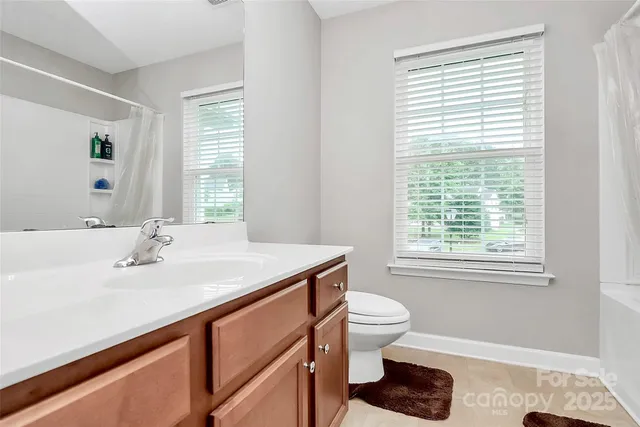 a bathroom with a sink toilet and window