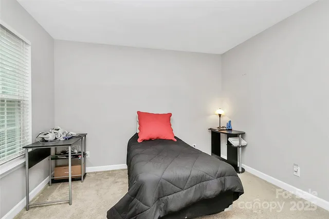 a bedroom with a bed and a chair