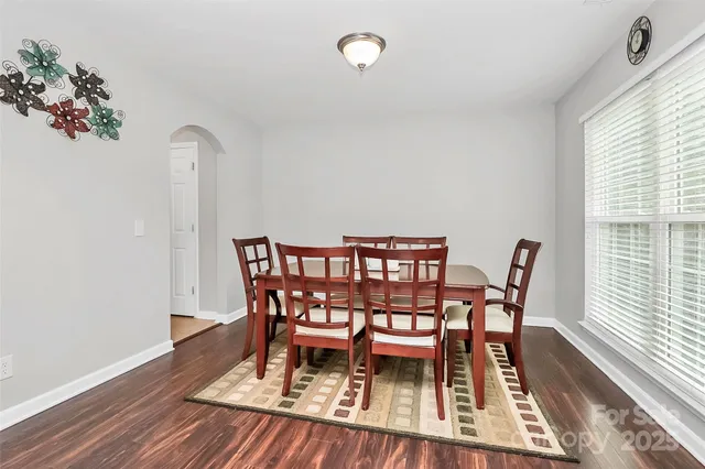a dining room with furniture and wooden floor