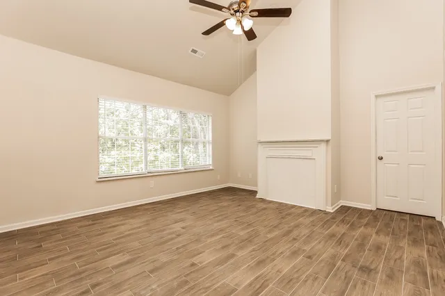 wooden floor in an empty room with a window