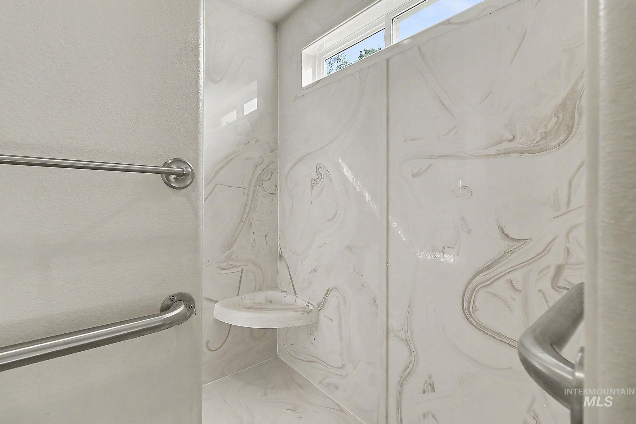 6900 West Charters Lane Melba, ID 83641 - Photo 34 of 49 Shower with patterned wall panels, built-in corner seat, and window