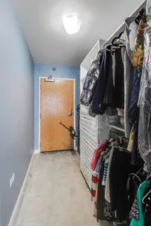 a view of walk in closet with clothes and shoes