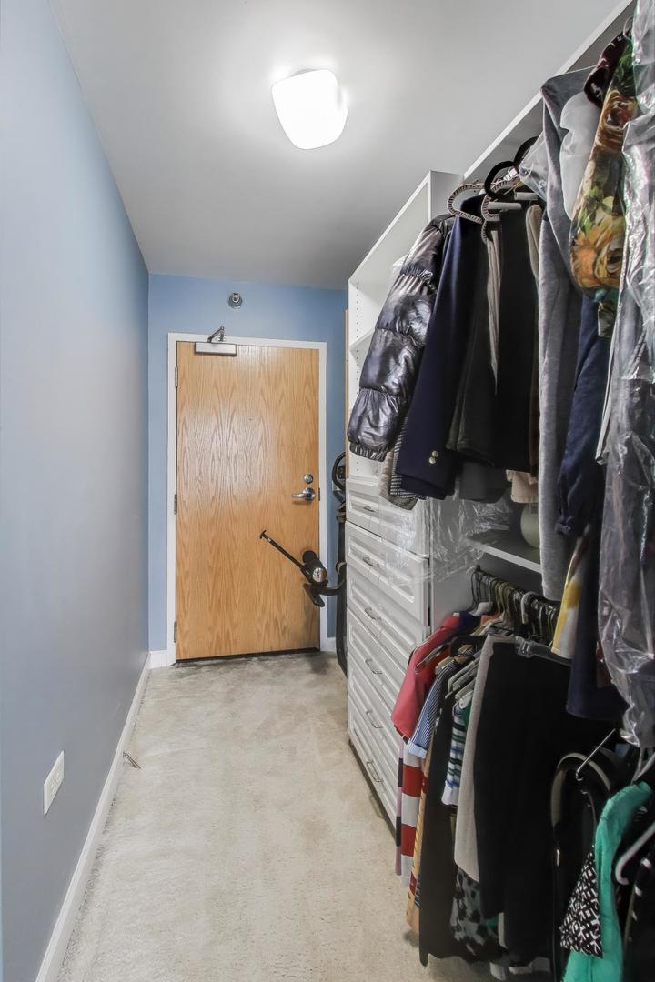 1529 South State Street, Unit 14J Chicago, IL 60605 - Photo 12 of 30 a view of walk in closet with clothes and shoes