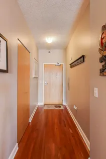 a view of a hallway with wooden floor