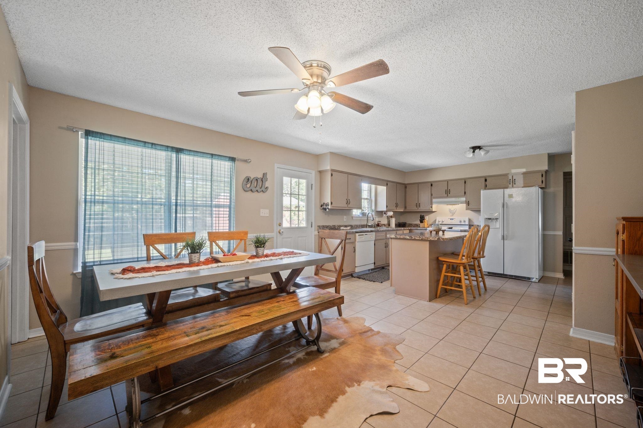 13025 County Road 55 Foley, AL 36535 - Photo 9 of 49 Tiled dining area with ceiling fan, a textured ceiling, and sink