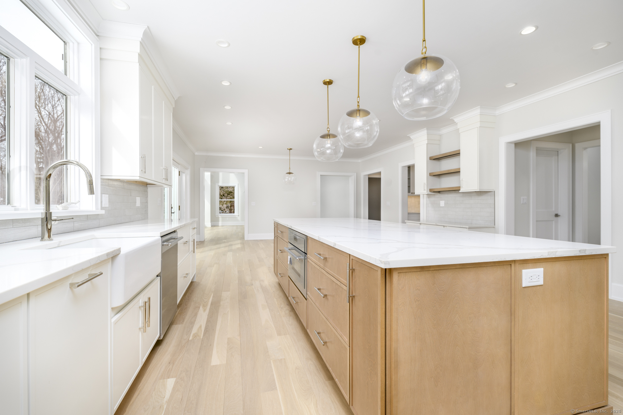 40 Hoyclo Road Stamford, CT 06903 - Photo 14 of 38 an open kitchen with a sink and dishwasher with wooden floor